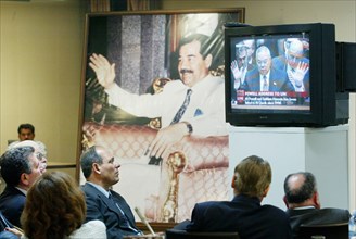 Baghdad, iraq, 2/03, iraqis watch colin powell's presentation to the un on iraq and weapons of mass destruction.