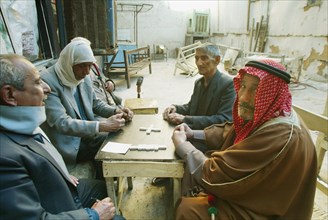 Baghdad, iraq, february 14 2003: a group of old men sit playing dominoes (in pic) in the central part of baghdad, (photo itar-tass / vitaly belousov).