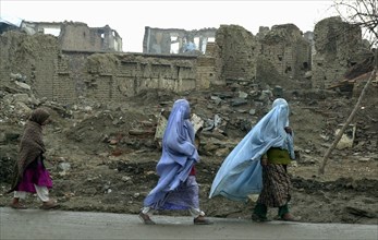 Kabul, afghanistan 2/03, veiled women hurrying through the ruins of the capital.