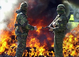 Tajikistan, march 12 2003, russian border guards serving on the tajik-afghan frontier pictured burning drugs confiscated from the traffickers , (photo itar-tass/ sergei zhukov).