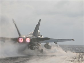 Uss 'theodore roosevelt' aircraft carrier, mediterranean sea, march 26 2003, a hornet fa-18 fighter pictured taking off from the flying-on deck of the uss 'theodore roosevelt' aircraft carrier for an ...