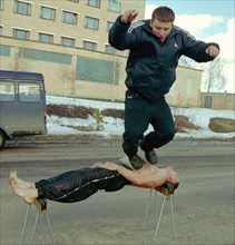 Physical endurance; firefighters, bryansk, russia, march 27 2003, captain of the russian interior ministry forces, guard commander of a bryansk fighfighters' unit mikhail karpeshin (bottom) demonstrat...