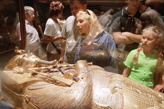 Caption: egypt, the russian tourists at a gold sarcophagus of pharaoh tutanhamona (in picture), despite military actions in iraq, the quantity of the russian tourists leaving on rest to egypt, was not...