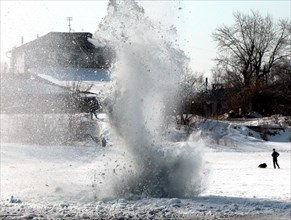 Caption: tas31: kurgan, russia, april 3, 2003, ice being blown near the water power development on the tobol river in kurgan to prevent spring floods and possible damage of water power facilities, (ph...