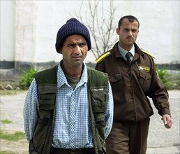 A drug-trafficer arrested by the tajik police, tajikistan, april 16, 2002, 40-year-old safar rakhmonov (l) was captured with 30 kg of heroin in his belongings by russian border guards and local police...