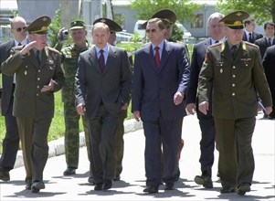 President vladimir putin (2nd l) and defence minister sergei ivanov (2nd r) visiting the 201st russian motorized division, stationed in tajikistan, on sunday, april 27, 2003.