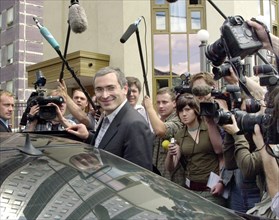 Mikhail khodorkovsky, the head of the yukos oil company and russia's wealthiest man, seen surrounded by reporters upon leaving the general prosecutor's office