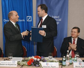 Tessen von heydebreck (deutsch bank ag) (l) and charles rhine (united financial group) exchanging documents during signing buisness cooperation agreement in hotel 'balchug-kempinsky' on thursday,  bor...