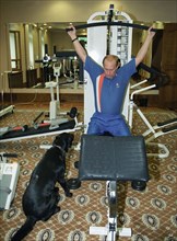 Russian president vladimir putin during a physical training session in a gym at his country residence in novo-ogaryov in the moscow region, june 16, 2003.