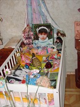 The portrait, bed and toys of a 4-year-old diana - the daughter of a construction engineer vitaly kaloyev, who is suspected of the murder of an air traffic controller peter nielsen, north ossetia, rus...