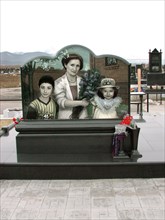 The tombstone with portraits of family members of construction engineer vitaly kaloyev - wife svetlana (c), daughter diana (r) and son kostya, kaloyev is suspected of the murder of a swiss air traffic...