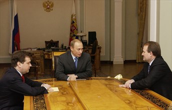 Head of the russian presidential staff dmitry medvedev (left), russian president vladimir putin (c), and viktor medvedchuk, chief of staff of the ukrainian president talk during the meeting, moscow,ru...