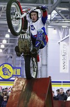 Dirt bikers demonstrate their skills at 'moscow international motor-park-2004' at crocus expo center, moscow, russia, 2004.