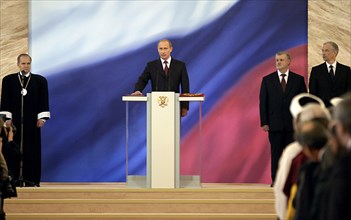 President vladimir putin (c) taking an oath during ceremony of his inauguration, chairman of the russian constitutional court valery zorkin (l) and chairman of houses of federal assembly sergei mirono...