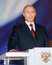 President vladimir putin taking the oath of office during his inauguration ceremony in st,andrew's hall in the kremlin on friday, may 7, 2004.