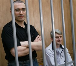 Former yukos oil major chief mikhail khodorkovsky (l) and his business partner, main yukos shareholder platon lebedev, listen during the hearing of their case in district court in moscow, august 19, 2...