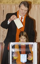 Ukraine election 2004, ukrainian opposition leader and presidential candidate viktor yushchenko casts his ballot at a polling station in kiev as his daughter sofllka looks on, during the second round ...