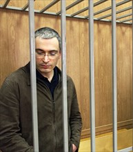 The ex-head of the yukos company mikhail khodorkovsky is standing while the verdict in the khodorkovsky, lebedev and krainov case is being read at  moscow’s meshchansky court, may 17, 2005.