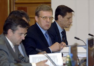 L to r: health and social development minister mikhail zurabov, russian minister of finance alexei kudrin (center) and deputy prime minister alexander zhukov attend a sitting of the russian cabinet on...