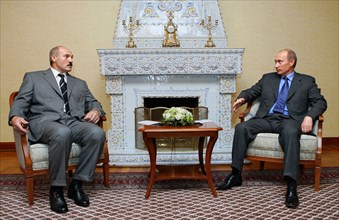 Russian president vladimir putin (r) and his belarussian counterpart alexander lukashenko are talking by a fireplace in putin's state residence rus in zavidovo, july 20, 2005.
