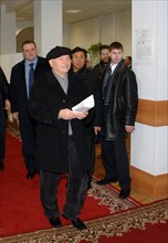 Moscow mayor yuri luzhkov (front) and his press secretary sergei tsoi (background c) arrive at a polling station during moscow city duma elections, moscow, russia, december 4, 2005.