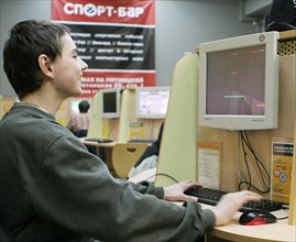 A boy enjoying himself at the cafemax internet centre in pyatnitskaya, moscow, russia.