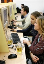 Young women drinking beer at the cafemax internet centre in pyatnitskaya, moscow, russia.