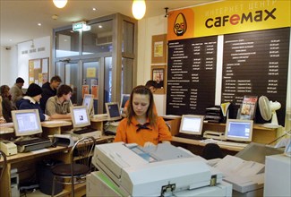 A young woman emloyee using a copy machine at the cafemax internet centre in pyatnitskaya, moscow, russia.