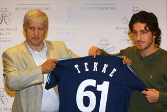 St, petersburg, russia, august 2, 2006, fc zenit president sergei fursenko, left, and turkish national team forward fatih tekke hold a soccer shirt bearing the number 61 and tekke's name as they pose ...