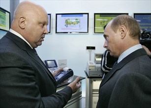 Russian president vladimir putin, right, listens to alexander goncharuk, president of joint stock financial corporation sistema, as they attend a sitronics exhibition in zelenograd, 24 miles north-wes...