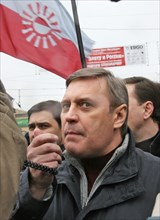 Leader of the russian people's democratic union mikhail kasyanov speaks into a megaphone at an opposition rally “the march of those who disagree” in support of the yabloko party, march 4,2007, moscow,...