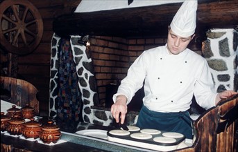 Cook in kitchen of yolki-palki russian-style fast food restaurant, moscow, russia 2/00.