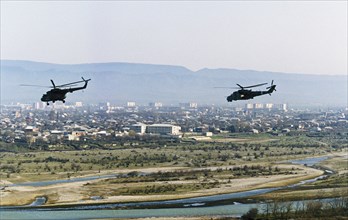 Russian military helicopters flying over gudermes, chechnya during the second chechen war, april 4, 2000.