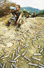 Second chechen war, russian soldiers taking a break after a fierce battle with chechen rebels, in the foreground are spent rebel shells, chechnya, june 2000.