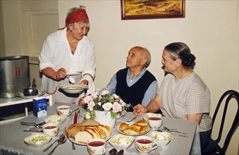 A poor old couple receiving a free meal at the yakimanka social security center in moscow which also provides free medical care to impoverished senior citizens, russia, 2000.