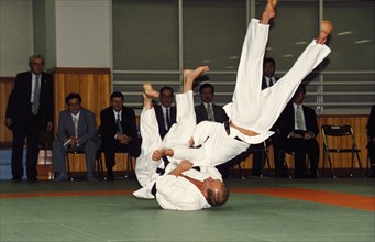 Russian president vladimir putin throwing an opponent at a judo demonstration during his state visit to japan in september 2000, tokyo.
