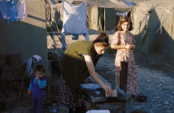 A mother with her children in a chechen refugee camp in karabulak, ingushetia, october 2000.