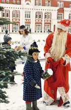Ded moroz (grandfather frost) and the snow maiden giving presents to poor children of large families, mordovia region, russia, 2000.