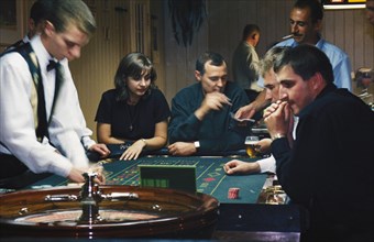 Gamblers at a roulette table ina casino in bashkiria, russia, 2001.