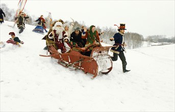 The pesnokhorki folk ensemble riding in a sleigh during a winter festival in barnaul, russia, 2001.