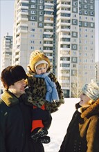 Young teachers with their child outside of new accomdations in chelyabinsk, russia.