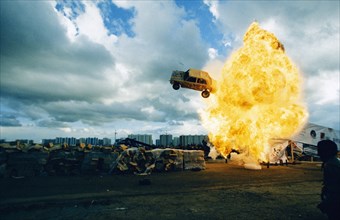 A car flying through a ball of fire at the 4th international stunt driving festival in khodynskoye field, moscow, may 2001.