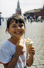 A young girl enjoying an ice cream in red square, moscow, july 2001.