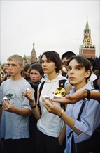 Young demonstrators holding a candle light vigil in red square in moscow to potest the import of nuclear waste into russia, july 2001.