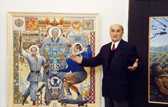 Artist oleg reyevich with his work 'trinity' which depicts putin, yeltsin, and lukashenko (president of belarus), february 2002.