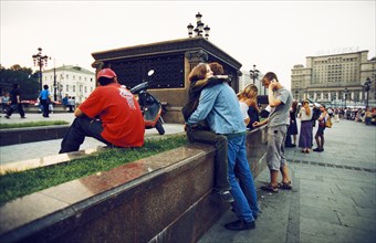 A young couple hugging in manege square, moscow, august 2002.