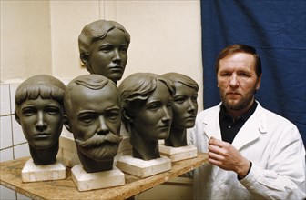 Dr, nikitin with sculptures of the heads of tsar nicholas and the romanov royal family reconstructed from their skulls, moscow, russia, 1996.