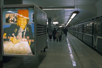 Metro system advertisement in the bratislavskaya metro station reads 'we've gotten closer', moscow 1997.
