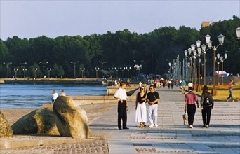 People strolling along the shore of lake onega, petrozavodsk, karelia, russia.