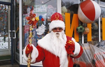 A man dressed as ded moroz (grandfather frost) selling christmas trinkets in moscow, russia.